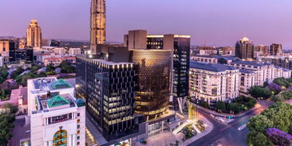 Sandton City panorama at dusk with the Leonardo building, Michelangelo apartments and sandton city office towers.
Sandton has become home to most of the major financial, consulting and banking firms in South Africa.  Sandton houses approximately 300000 residents and 10 000 businesses, including investment banks, top businesses, financial consultants, the Johannesburg stock exchange and one of the biggest convention centres on the African continent, the Sandton Convention Centre.